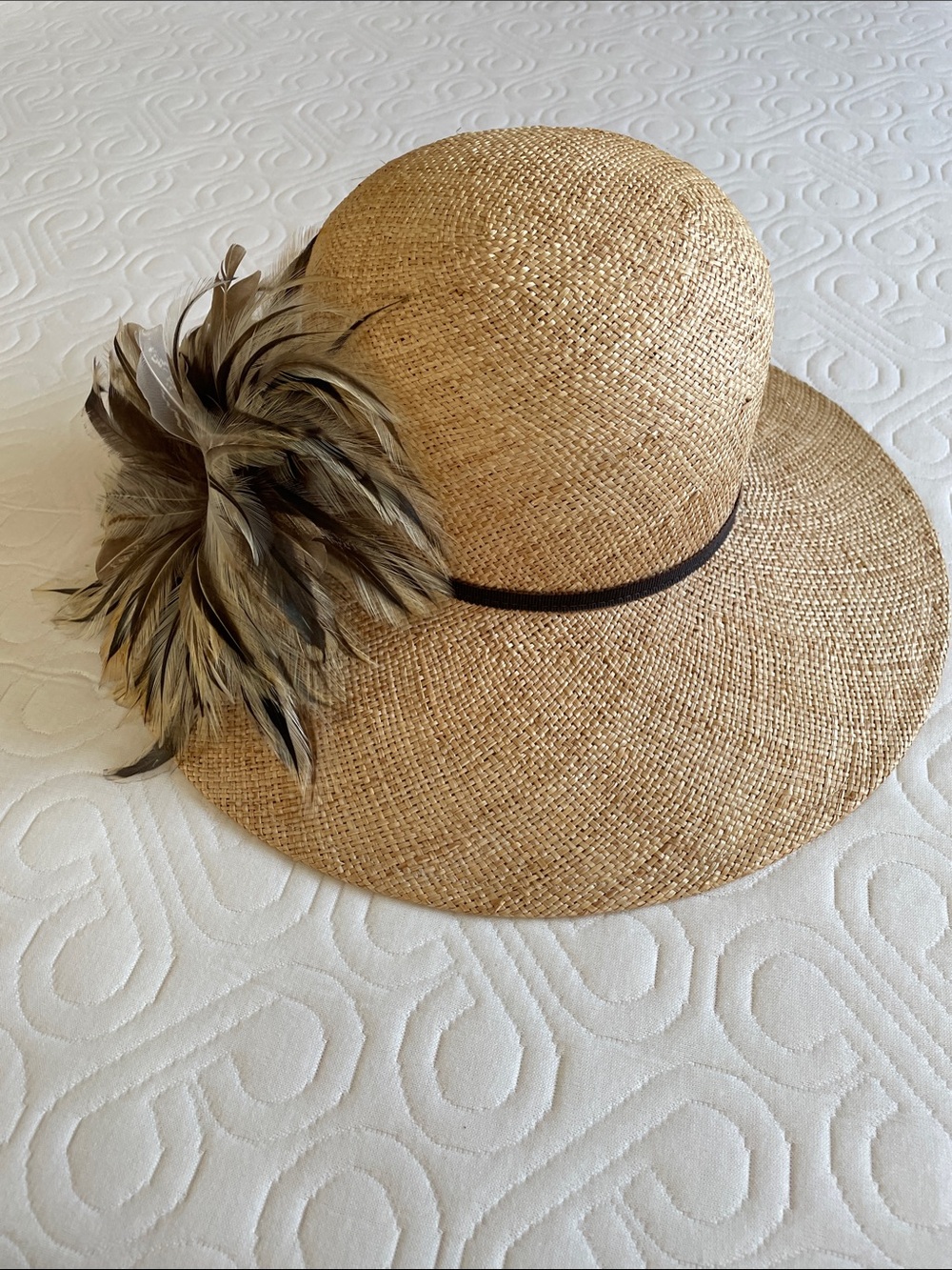 Woven straw sun hat with feather fascinator
